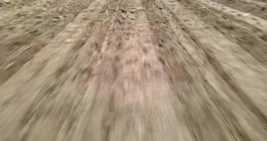 Moving camera, The tractor is plowing the soil in preparation for planting crops. The marks of the tractor on a sunny day. video