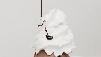 Close up, Chocolate sauce below the layers of whipped cream. Whipped cream on ice cream. On the white background. video