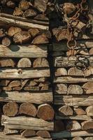 Detail of a pile of cut rustic wood in a sunny day, forming a singular background on a farm near Bento Goncalves. A friendly country town in southern Brazil famous for its wine production. photo