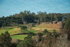 Charming country houses on top of hill with green fields, in a wooded landscape near Bento Goncalves. A friendly country town in southern Brazil famous for its wine production. photo