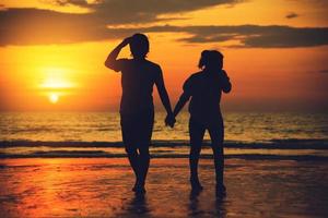 Asian lovers happy and having fun holding hands. Travel beach summer vacation. photo