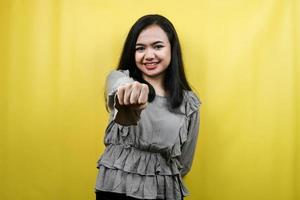 Beautiful young woman with hands punching at camera, punching at audience, isolated photo