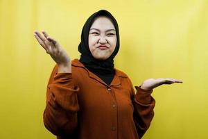 Beautiful asian young muslim woman with i don't know sign expression, isolated photo