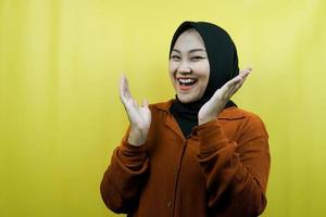 Beautiful young asian muslim woman shocked, surprised, wow expression, facing camera isolated photo