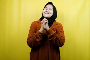 Beautiful and cheerful young asian muslim woman, hands on face, isolated photo