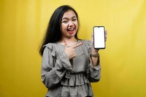 Beautiful young woman hands holding smartphone with blank or white screen, surprised, wow expression, promoting app, promoting product, advertisement, isolated photo