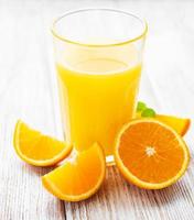 vaso de jugo y frutas de naranja foto