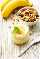 Banana yogurt, granola and fresh bananas photo
