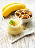 Banana yogurt, granola and fresh bananas photo