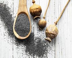 Poppy seeds in small wooden spoon