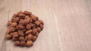 Black Chickpeas or Kala Chana with chana dal pulse isolated on wooden Background. photo