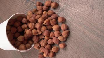 Black Chickpeas or Kala Chana with chana dal pulse isolated on wooden Background. photo