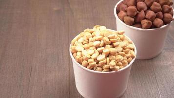 Black Chickpeas or Kala Chana with chana dal pulse isolated on wooden Background. photo