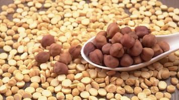Black Chickpeas or Kala Chana with chana dal pulse isolated on wooden Background. photo