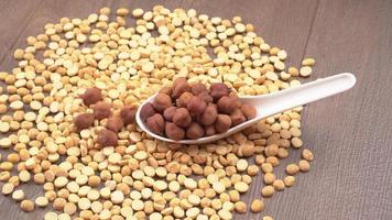 Black Chickpeas or Kala Chana with chana dal pulse isolated on wooden Background. photo