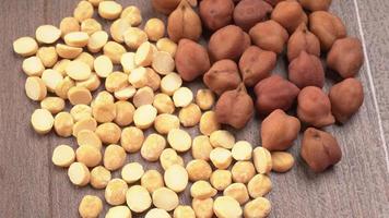 Black Chickpeas or Kala Chana with chana dal pulse isolated on wooden Background. photo
