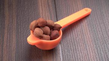 Black Chickpeas or Kala Chana with chana dal pulse isolated on wooden Background. photo