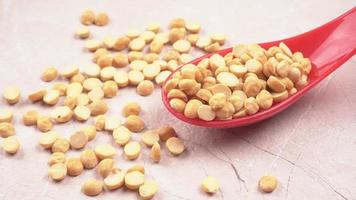 Black Chickpeas or Kala Chana with chana dal pulse isolated on wooden Background. photo