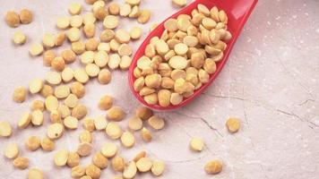 Black Chickpeas or Kala Chana with chana dal pulse isolated on wooden Background. photo