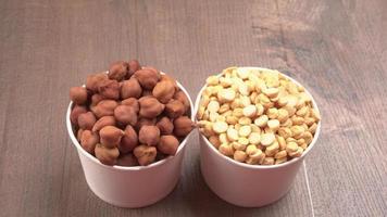 Black Chickpeas or Kala Chana with chana dal pulse isolated on wooden Background. photo