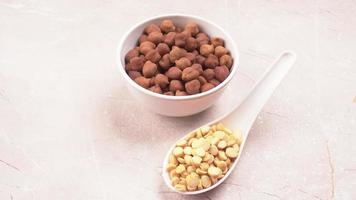 Black Chickpeas or Kala Chana with chana dal pulse isolated on wooden Background. photo