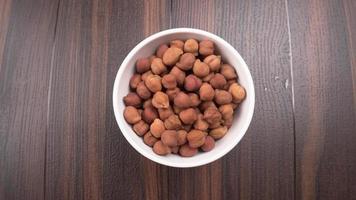 Black Chickpeas or Kala Chana with chana dal pulse isolated on wooden Background. photo