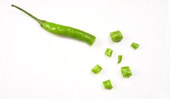 Fresh long Indian green chillies on wooden background. photo