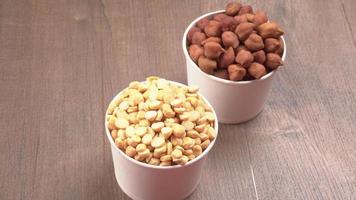 Black Chickpeas or Kala Chana with chana dal pulse isolated on wooden Background. photo