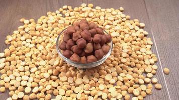 Black Chickpeas or Kala Chana with chana dal pulse isolated on wooden Background. photo