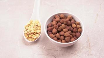 Black Chickpeas or Kala Chana with chana dal pulse isolated on wooden Background. photo