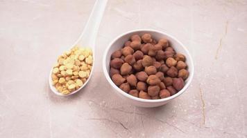 Black Chickpeas or Kala Chana with chana dal pulse isolated on wooden Background. photo