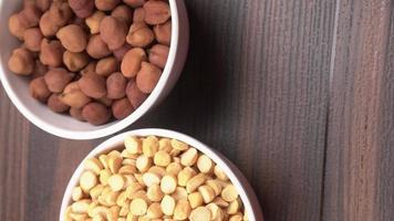 Black Chickpeas or Kala Chana with chana dal pulse isolated on wooden Background. photo