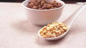 Black Chickpeas or Kala Chana with chana dal pulse isolated on wooden Background. photo