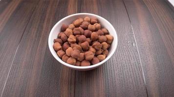 Black Chickpeas or Kala Chana with chana dal pulse isolated on wooden Background. photo