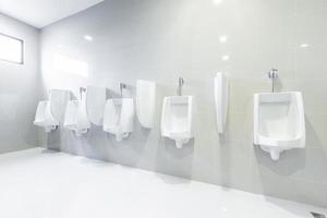 urinarios de baños públicos alineados, sin privacidad.