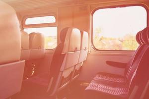 Empty seats in train wagon indoor. Interior lithuanian countryside travel. photo