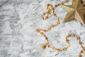 New Year's or Christmas composition of New Year's, shiny golden toys and stars on a bright textural background photo