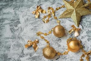 New Year's or Christmas composition of New Year's, shiny golden toys and stars on a bright textural background photo