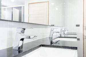 public Interior of bathroom with sink basin faucet lined up Modern design. photo