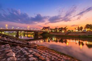 Natural evening at view the Nan River and the Naresuan Bridge in the park for relaxing walking jogging and exercise at sunset in Phitsanulok City, Thailand. photo