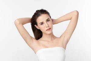 Beautiful Young Asian woman lifting hands up to show off clean and hygienic armpits or underarms on white background, Smooth armpit cleanliness and protection concept photo
