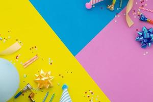 Happy birthday background, Flat lay colorful party decoration on pastel yellow, blue and pink geometric background photo