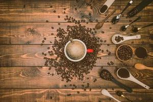 Brown coffee beans And a cup of hot coffee placed on a wooden table with honey. Wooden background and espresso and beans. Top view with copy space for your text. photo