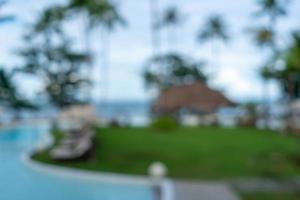 Blurry resort and hotel with a swimming pool and a beach chair photo