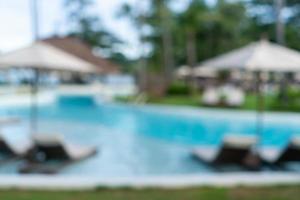 Blurry resort and hotel with a swimming pool and a beach chair photo