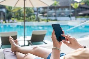 Woman hand using smartphone to do work business, social network, communication. photo