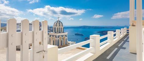 Beautiful landscape from Oia town on Santorini island, Greece. Traditional and famous houses and churches with blue domes over the Caldera, Aegean sea photo