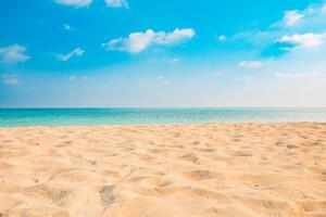 Closeup of sand on beach and blue summer sky. Panoramic beach landscape. Empty tropical beach and seascape. Orange and golden sunset sky, soft sand, calmness, tranquil relaxing sunlight, summer mood photo