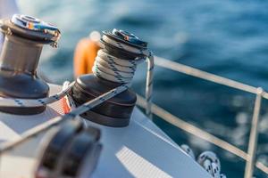 details of sailing equipment on a boat when sailing on the water in a sunny day photo