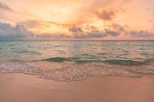 Closeup sea sand beach. Panoramic beach landscape. Inspire tropical beach seascape horizon. Orange and golden sunset sky calmness tranquil relaxing sunlight summer mood. Vacation travel holiday banner photo